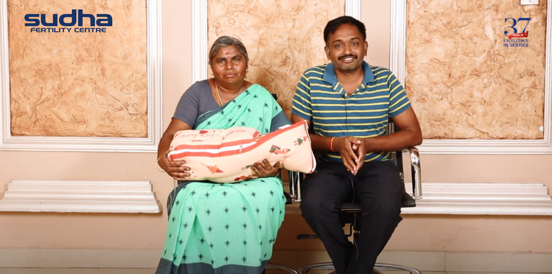 A man and his mother in law holding healthy baby at Sudha Fertility Centre Chennai - the best fertility hospital in chennai